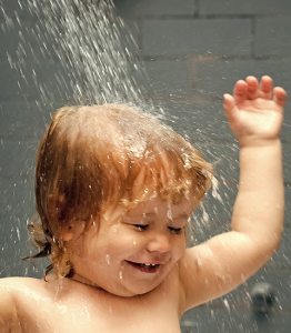 Cute Happy Smiling Baby Relaxing in the Shower