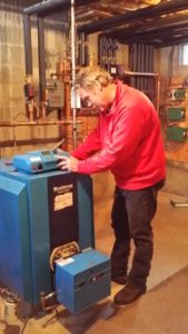 Technician Repairs Boiler